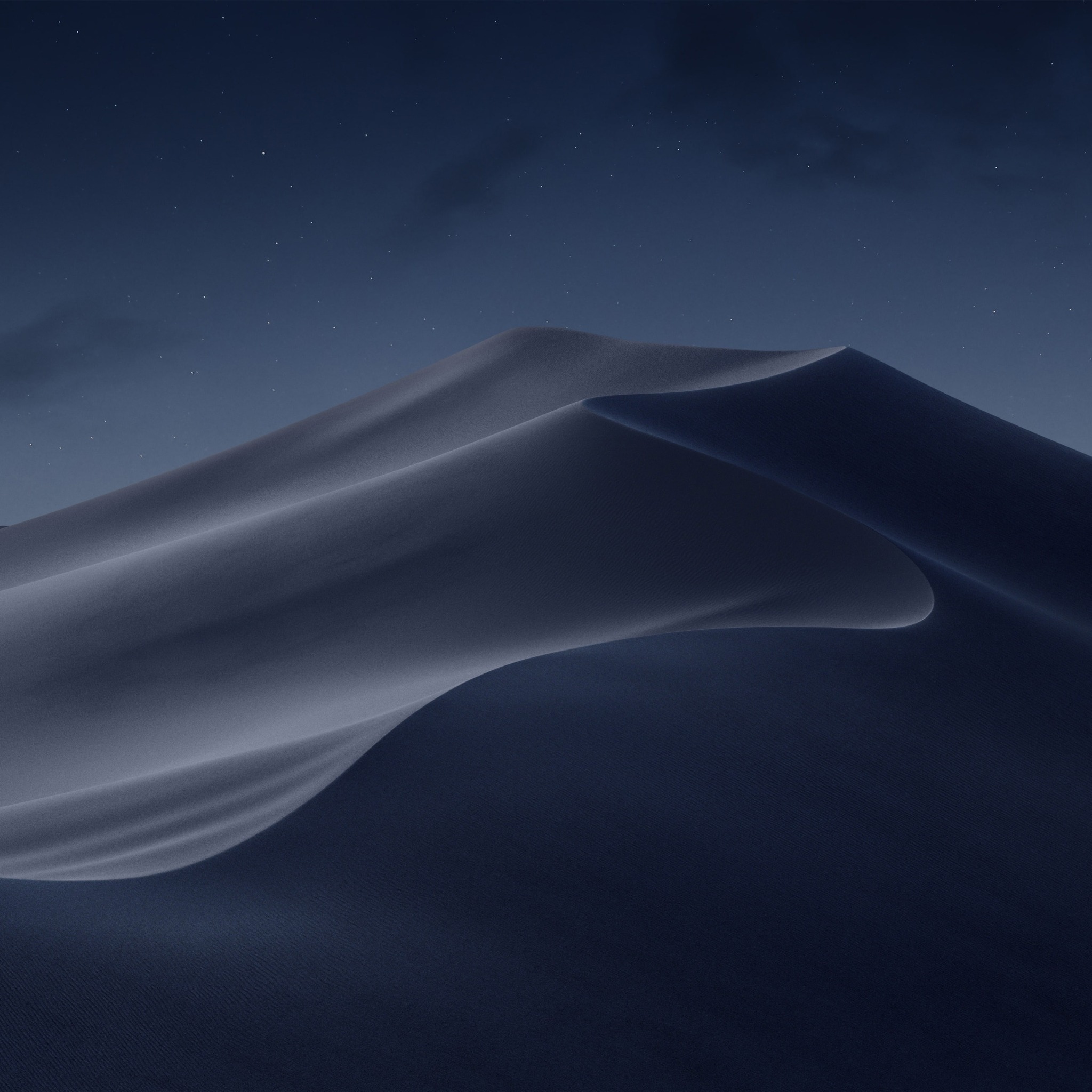 Desert dunes beneath a dark night sky